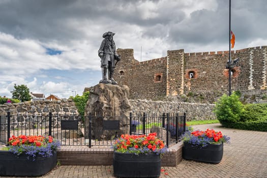 Carrickfergus, UK, Aug 2019 King William III bronze statue overlooking the harbour and marina, located in front of Carrickfergus Castle