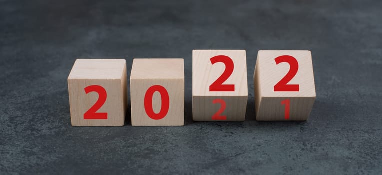 Changing the year 2021 to 2022, wooden cubes with red numbers, dark background