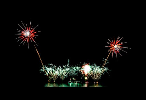 Colorful fireworks light up and explosion on black sky with copy space for greeting text. New year celebration and anniversary concept