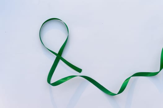 Green Ribbon on white background. Table top view. copy space for text