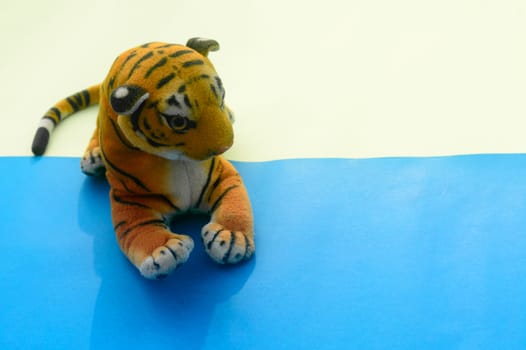 Royal Bengal Tiger Soft Stuffed Plush Toy Teddy Bear for Kids on color background. High angle view. Copy space for text.