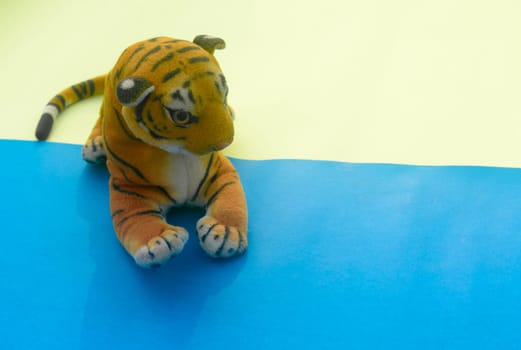 Royal Bengal Tiger Soft Stuffed Plush Toy Teddy Bear for Kids on color background. High angle view. Copy space for text.