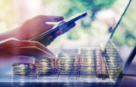 Double exposure, Technology network and online banking and internet banking and networking people concept, Hand young women with notebook computer and laptop, phone, cellphone, tablet, smartphone mobile, and credit card with coin money on business office table
