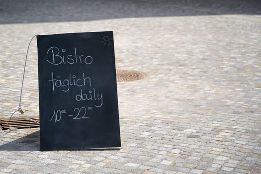 Sign in Berlin with the inscription Bistro open daily from 10:00 to 22:00