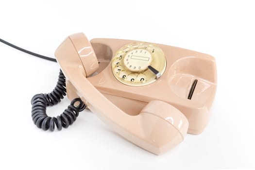 Vintage telephone. Pink old telephone isolated on white background.