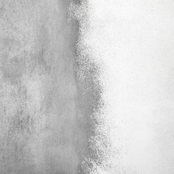 Decorative plaster surface. Grained abstract wall texture divided by half with white color putty.