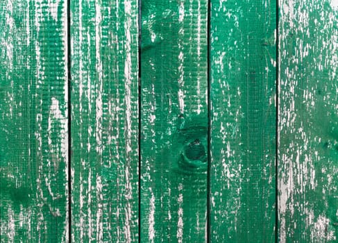 Wooden green planks. Background consisting of wooden planks, with peeling green paint.