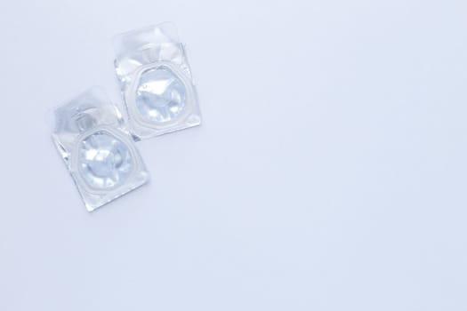 Contact lenses lie on the side on a white background.top view, flat lay, copy space, isolate. High quality photo