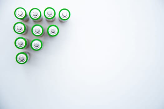 The batteries are arranged in a triangle in the upper corner of the photo on a white background. top view, flat lay, copy space, isolate. High quality photo