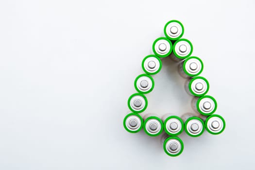 The batteries are in the shape of a Christmas tree on a white background. top view, flat lay, copy space, isolate. High quality photo