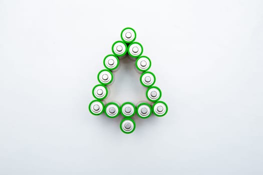 The batteries are in the shape of a Christmas tree on a white background. top view, flat lay, copy space, isolate. High quality photo