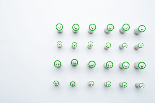 The batteries are arranged in a triangle in the upper corner of the photo on a white background. top view, flat lay, copy space, isolate. High quality photo