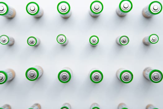 The batteries are arranged in a triangle in the upper corner of the photo on a white background. top view, flat lay, copy space, isolate. High quality photo