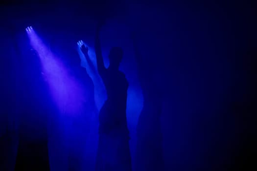 Spanish Flamenco dancer silhouette over dark blue background. Space for your design.