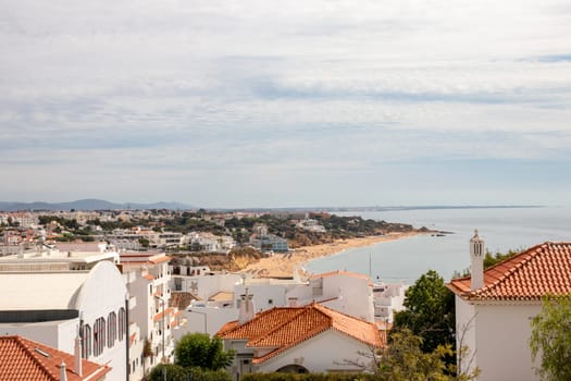 ALBUFEIRA, Portugal, - SEP 16, 2020. View over the rooftops of Albufeira to the beach of Albufeira (Praia do Peneco) in southern Portugal. A popular tourist destination in the Algarve.