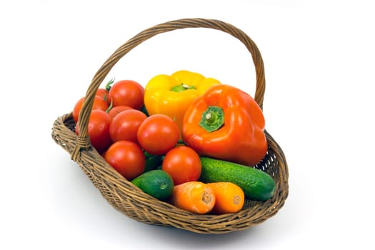 basket with fresh vegetables on white background