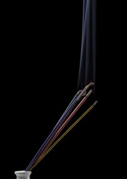 Burning indian or thai incense aroma sticks variety with smoke, isolated on black