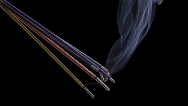 Burning indian or thai incense aroma sticks variety with smoke, isolated on black
