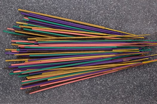 Indian or thai colorful incense aroma sticks variety scattered on a table, top view