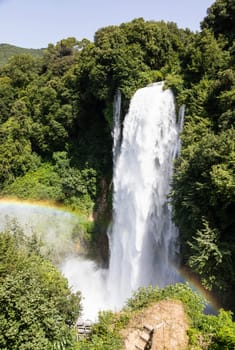 Marmore waterfall in Umbria region, Italy. Amazing cascade splashing into nature with trees and rocks.