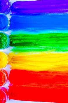 Colorful lines drawn horizontally from cans of paint in the form of a rainbow on a white background. top view, flat lay, copy space, isolate. High quality photo