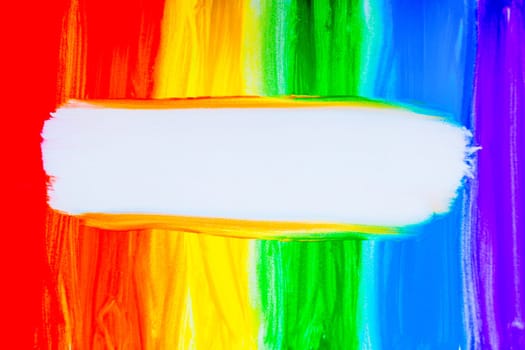 Colorful lines drawn vertically with paint in the form of a rainbow with a white place for text in the middle on a white background. top view, flat lay, copy space, isolate. High quality photo