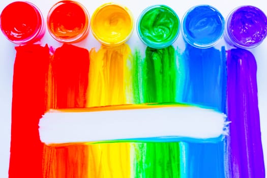 Colorful lines drawn vertically with paint in the form of a rainbow with a white place for text in the middle on a white background. top view, flat lay, copy space, isolate. High quality photo