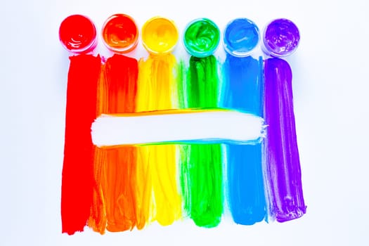 Colorful lines drawn vertically with paint in the form of a rainbow with a white place for text in the middle on a white background. top view, flat lay, copy space, isolate. High quality photo