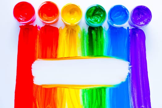 Colorful lines drawn vertically with paint in the form of a rainbow with a white place for text in the middle on a white background. top view, flat lay, copy space, isolate. High quality photo