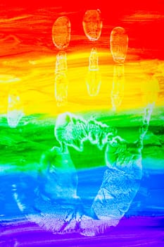 Colorful lines drawn horizontally with paint in the form of a rainbow with a handprint on a white background. LGBT PEOPLE. top view, flat lay, copy space, isolate. High quality photo