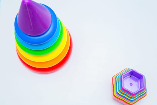 Children's educational toys: a pyramid and sorters lie on a white background with a place for text. top view, flat lay, copy space, isolate. High quality photo