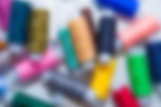Background blurry image. You can see the outlines of multi-colored threads that lie in a chaotic order. High quality photo