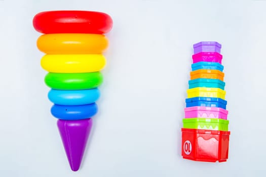 Children's educational toys: a pyramid and sorters lie on a white background with a place for text. top view, flat lay, copy space, isolate. High quality photo