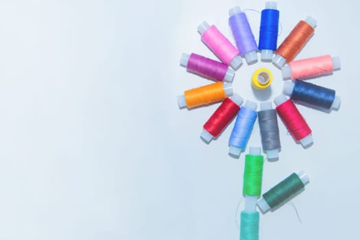 Skeins with threads are in the form of a creative flower on a white background. top view, flat lay, copy space, isolate. High quality photo