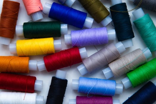 The background image. There are a lot of multi-colored threads that lie in a chaotic order. High quality photo