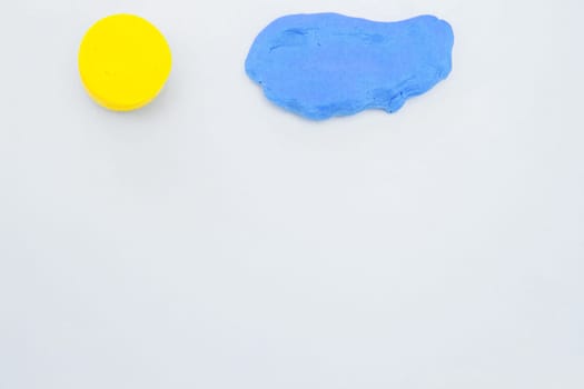 Dough for modeling in the form of a sun and a cloud on a white background. High quality photo