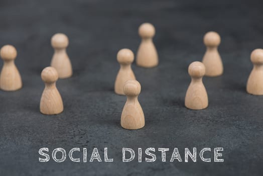 A group of woooden people keep social distance, Covid-19 pandemic regulations, dark background