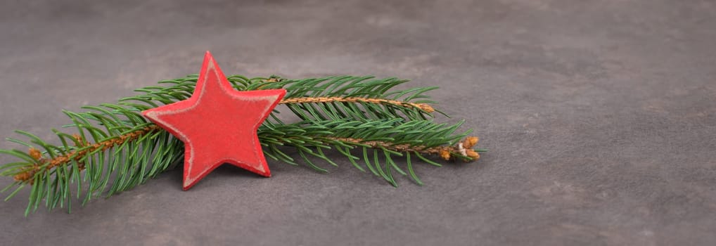 Empty sign with christmas decoration, branch of fir and cones, textured brown background