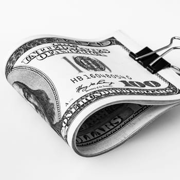 A stack of packaged dollars on a white background. One hundred American dollar bills. The pile of dollars is isolated with a shadow. Black and white style. A big wad of dollars. Place for logo, lettering, layout, layout.