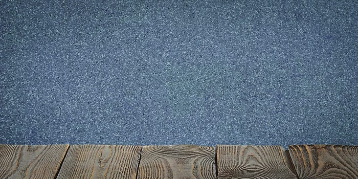 The background is blank wooden boards and a textured plastered wall with lighting and vignetting. For product demonstrations, free space, layout, mockup, perspective board, background board.