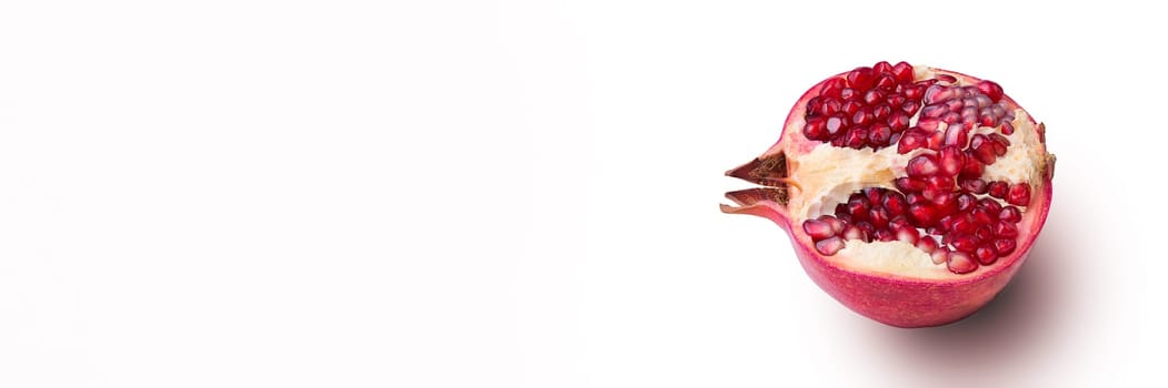 Garnet isolated part on a white background close-up with shadow. Fresh pomegranate. Juicy pomegranate. Delicious pomegranate. Place for advertising, logo, lettering, layout, mockup.