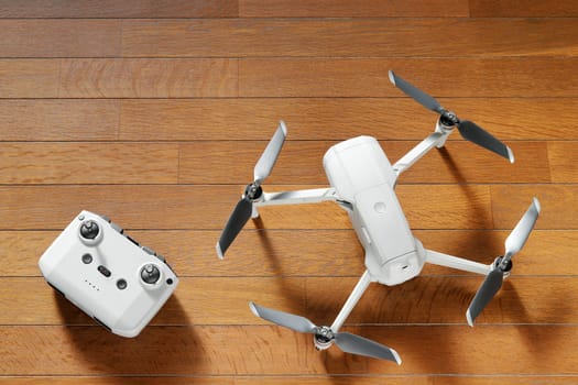 small drone copter with controller on a wooden background