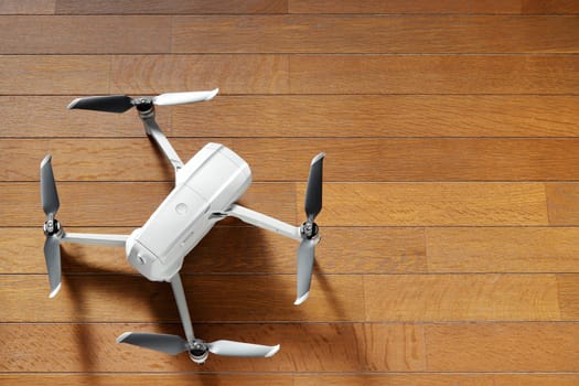 small drone copter on a wooden background