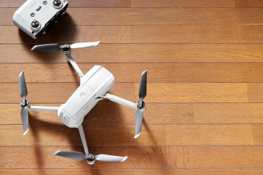small drone copter with controller on a wooden background