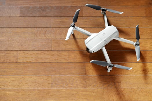 small drone copter on a wooden background