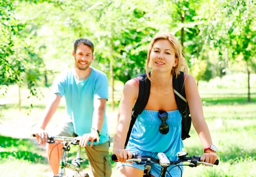 Young man and woman having a bike ride in nature
