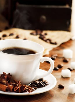 Cup of coffee and coffee mill in the background