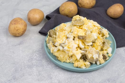 Potato salad on a blue coloredplate, traditional german food