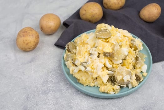 Potato salad on a blue coloredplate, traditional german food