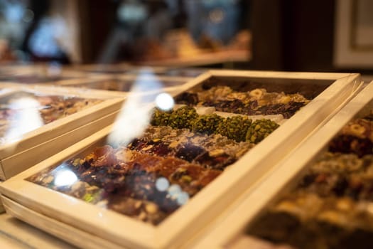 rows of Turkish delight sweets desserts in white cardboard packaging lined up in the store window
